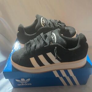 Adidas kids  Black Sneakers with White Stripes size 6. Fits women’s 7 or 7.5